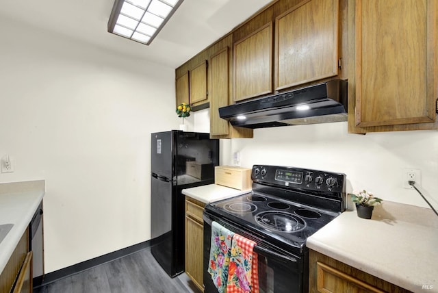 kitchen with dark wood-type flooring and black appliances