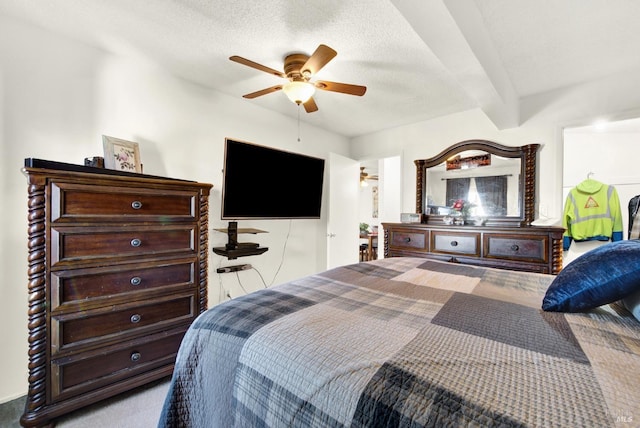 bedroom featuring a textured ceiling, beamed ceiling, and ceiling fan