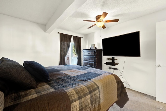 carpeted bedroom featuring a textured ceiling, beamed ceiling, and ceiling fan