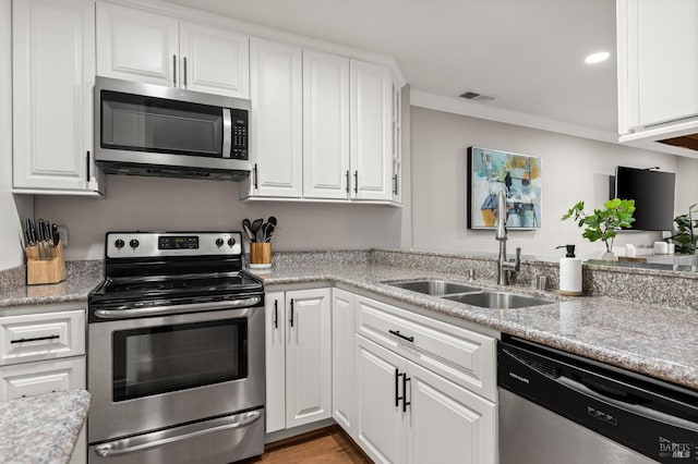 kitchen with white cabinetry, appliances with stainless steel finishes, sink, and crown molding