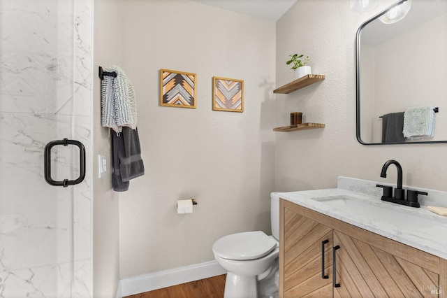 bathroom featuring vanity, hardwood / wood-style flooring, toilet, and walk in shower