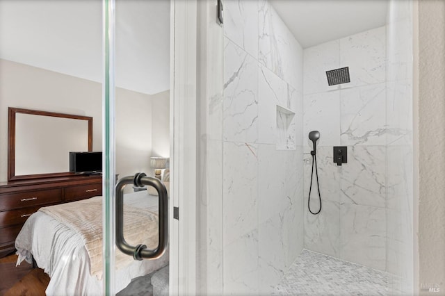 bathroom with an enclosed shower and wood-type flooring