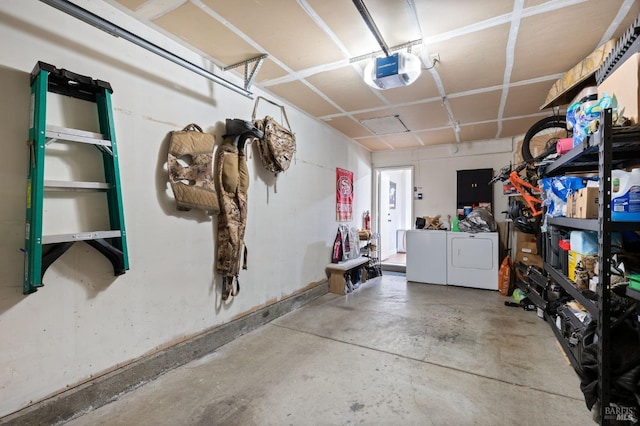 garage with a garage door opener and washer and clothes dryer