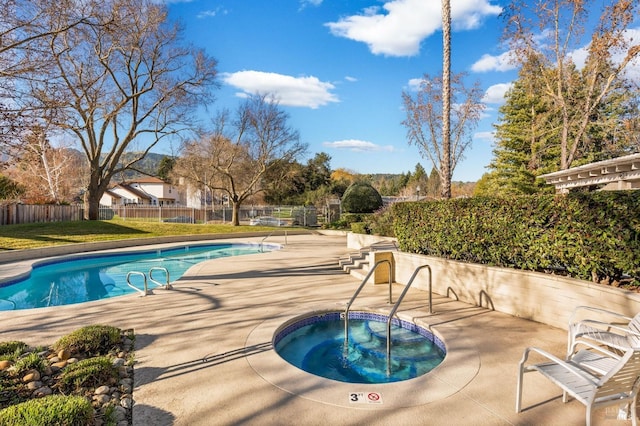 view of swimming pool with a community hot tub and a patio area