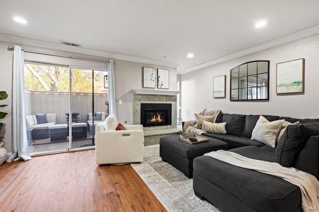 living room with crown molding and hardwood / wood-style flooring