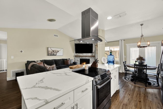 kitchen featuring light stone counters, white cabinets, lofted ceiling, stainless steel range with electric stovetop, and island range hood