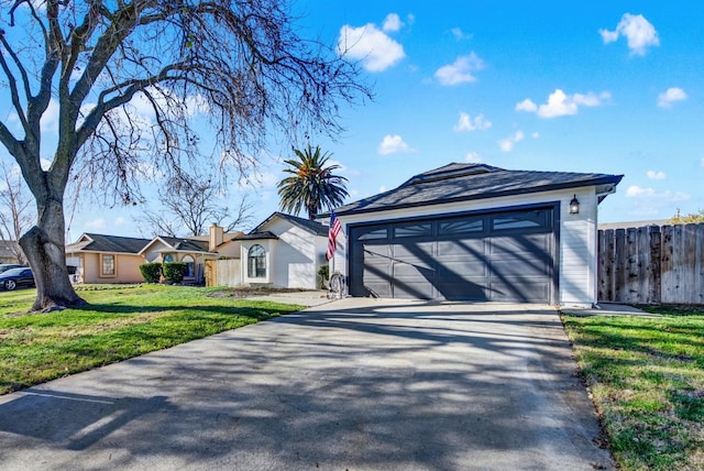 ranch-style house featuring a garage and a front yard