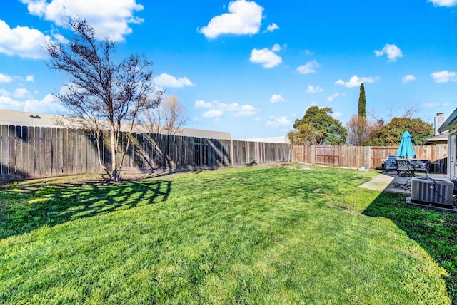 view of yard featuring a patio and central AC