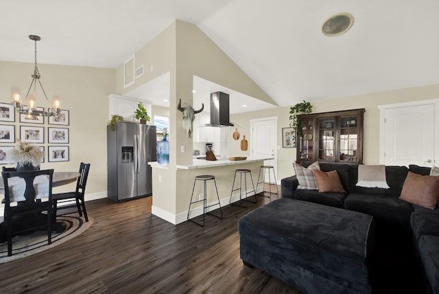 living room with high vaulted ceiling, a chandelier, and dark hardwood / wood-style floors