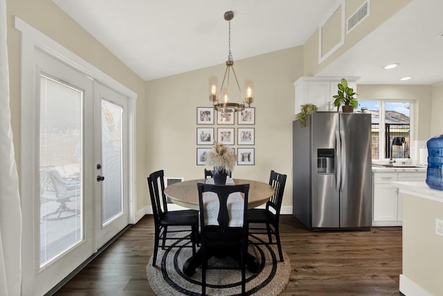 dining area featuring sink, french doors, a notable chandelier, and dark hardwood / wood-style flooring