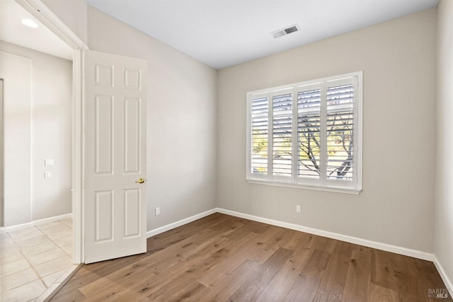 unfurnished room featuring light hardwood / wood-style floors