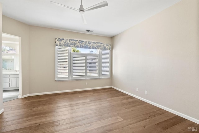 unfurnished room with ceiling fan and light wood-type flooring