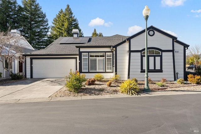 view of front of house with a garage and solar panels