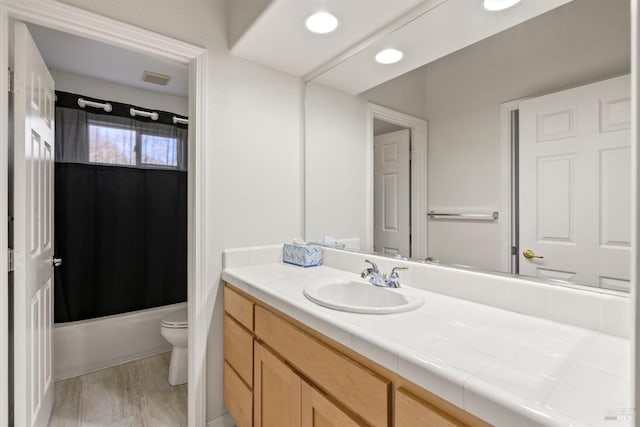 full bathroom featuring shower / bathtub combination with curtain, vanity, wood-type flooring, and toilet