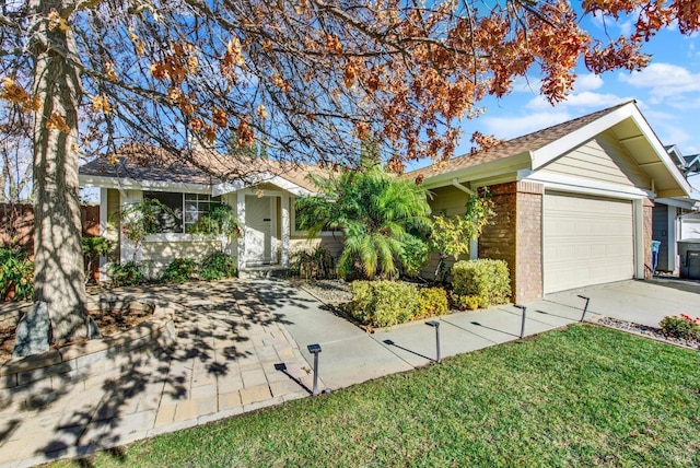 single story home featuring a garage and a front lawn