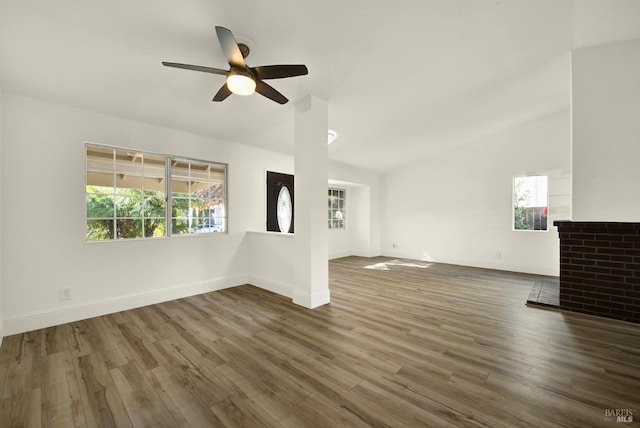 unfurnished living room featuring ceiling fan and dark hardwood / wood-style flooring