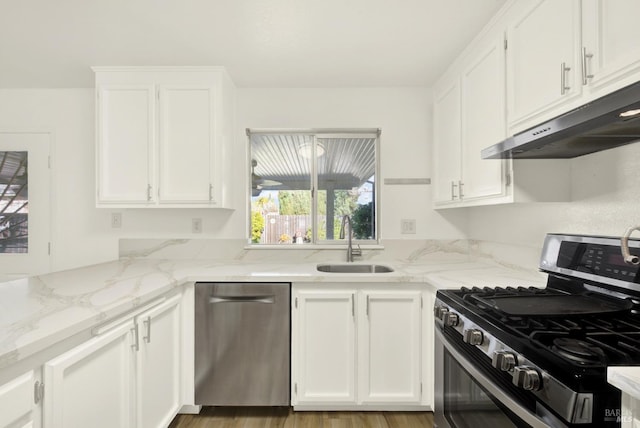 kitchen with dark hardwood / wood-style floors, sink, white cabinets, light stone counters, and stainless steel appliances