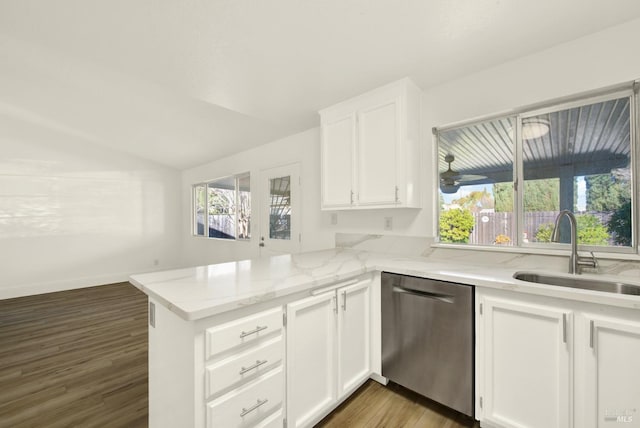 kitchen with white cabinetry, sink, stainless steel dishwasher, and kitchen peninsula