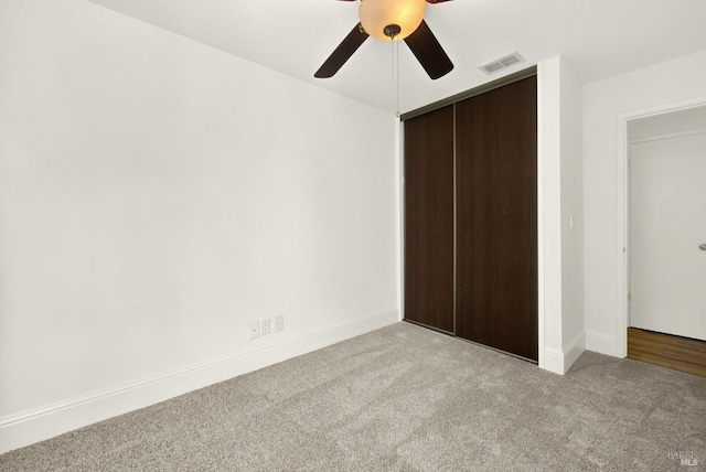 unfurnished bedroom with carpet floors, a closet, and ceiling fan