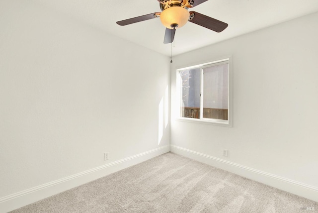 spare room featuring ceiling fan and light carpet