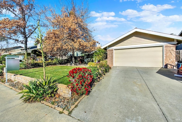 view of front of house with a garage and a front lawn