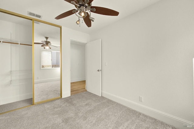 unfurnished bedroom with a closet, ceiling fan, and carpet