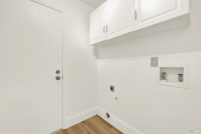 clothes washing area featuring cabinets, hookup for a gas dryer, hookup for a washing machine, hookup for an electric dryer, and light wood-type flooring