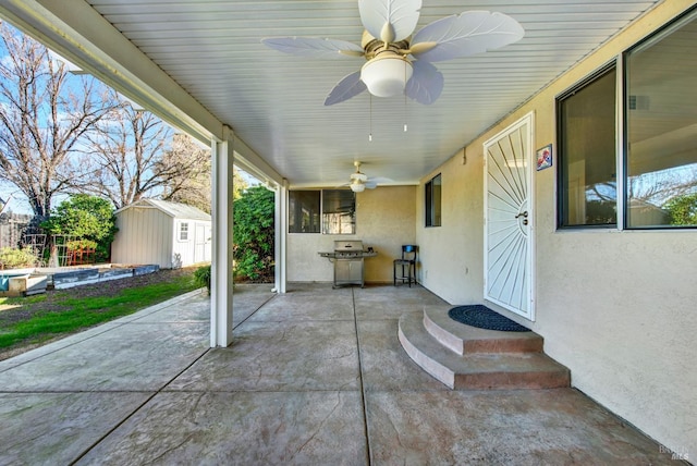 view of patio / terrace featuring a shed, grilling area, and ceiling fan