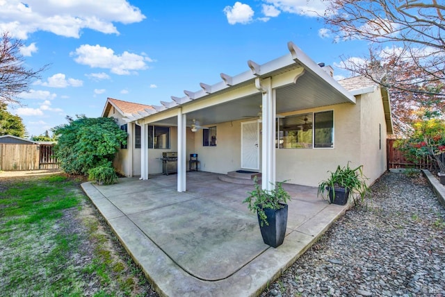 rear view of house with a patio area and ceiling fan