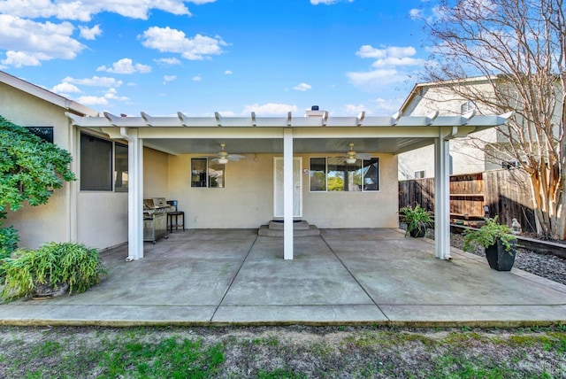 rear view of house featuring ceiling fan and a patio