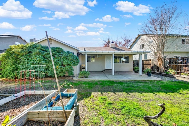 rear view of house featuring a yard and a patio area