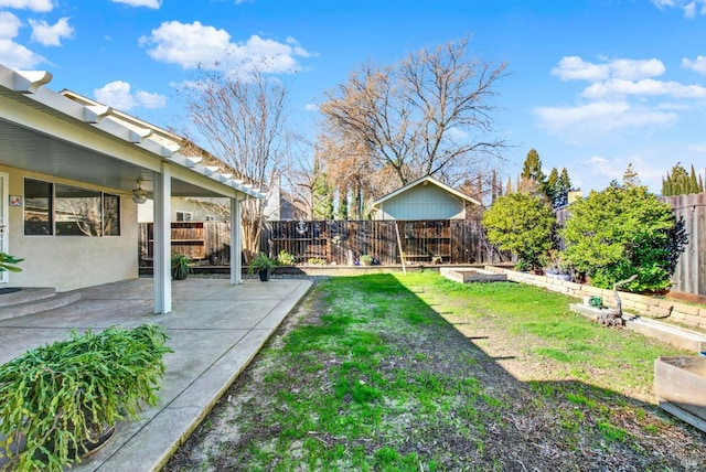 view of yard with ceiling fan and a patio area