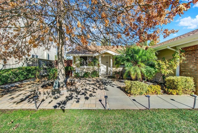 ranch-style home featuring a front yard