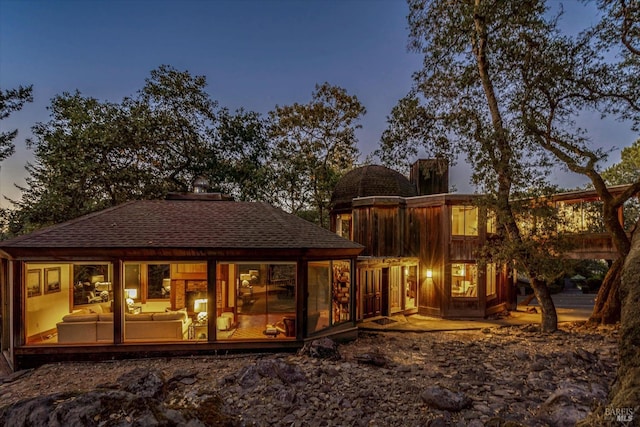 view of back house at dusk