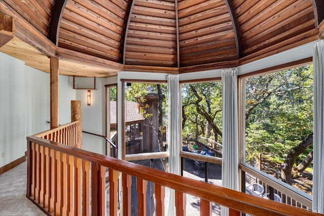 unfurnished sunroom featuring lofted ceiling with beams and wood ceiling