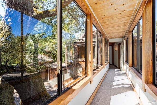 unfurnished sunroom with wood ceiling