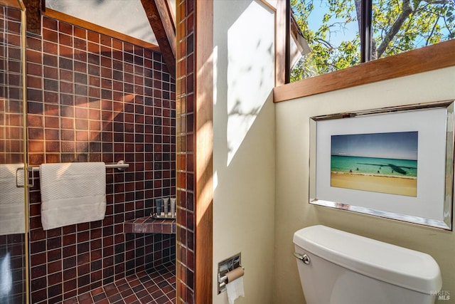 bathroom with toilet and tiled shower