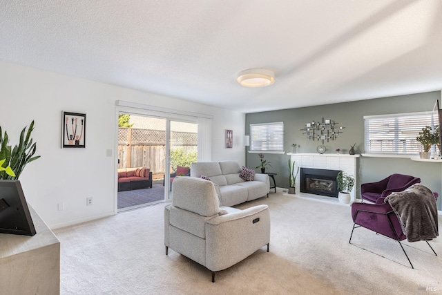 living room featuring a brick fireplace and light colored carpet