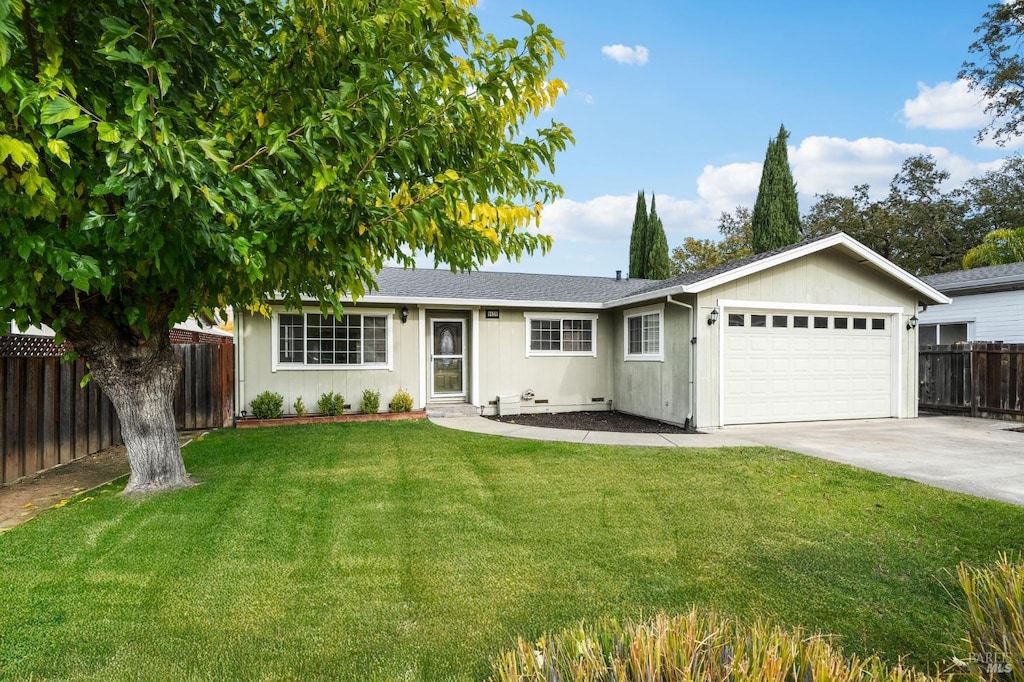 ranch-style home with a garage and a front lawn