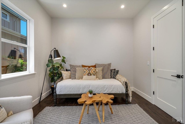 bedroom with dark hardwood / wood-style floors