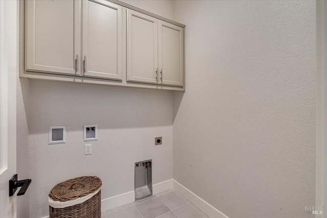 laundry room with cabinets, light tile patterned flooring, electric dryer hookup, and hookup for a washing machine