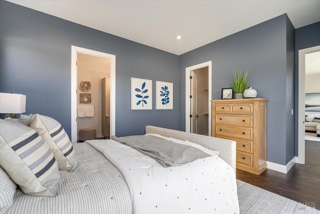 bedroom featuring connected bathroom and dark hardwood / wood-style floors