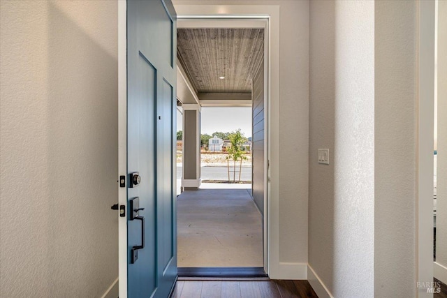 entryway with hardwood / wood-style flooring and wood ceiling