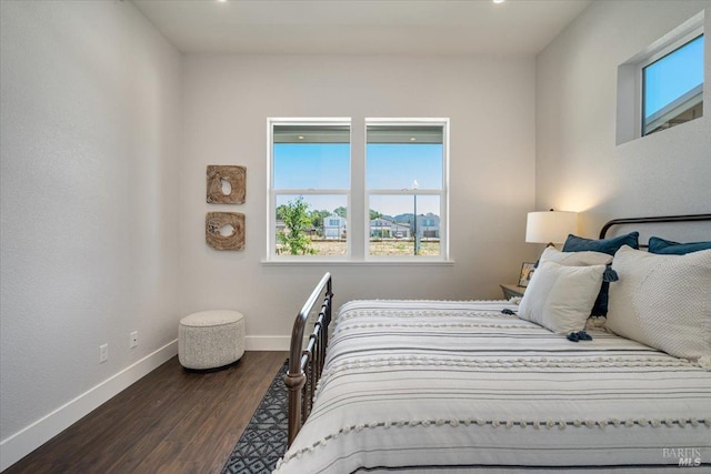 bedroom with dark hardwood / wood-style floors