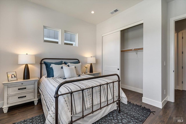 bedroom featuring dark hardwood / wood-style flooring and a closet