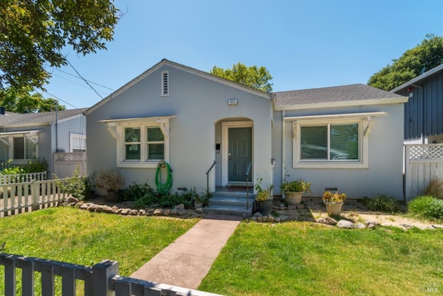 bungalow-style home featuring a front yard