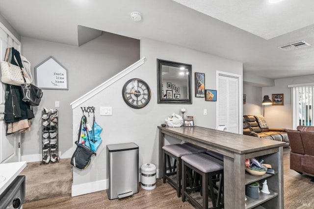 interior space with dark wood-type flooring and a kitchen bar