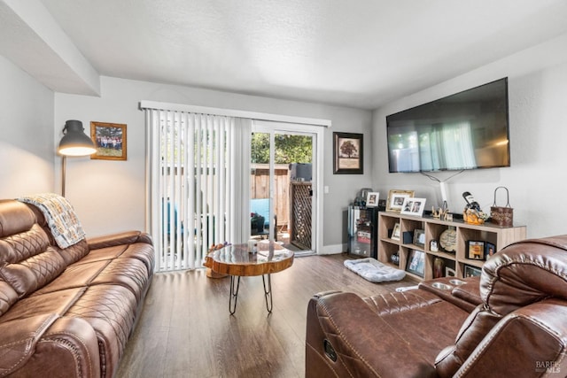 living room featuring hardwood / wood-style flooring and a textured ceiling