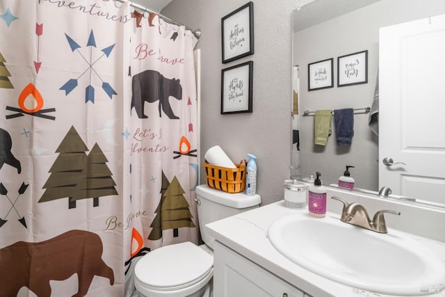 bathroom with vanity, curtained shower, and toilet