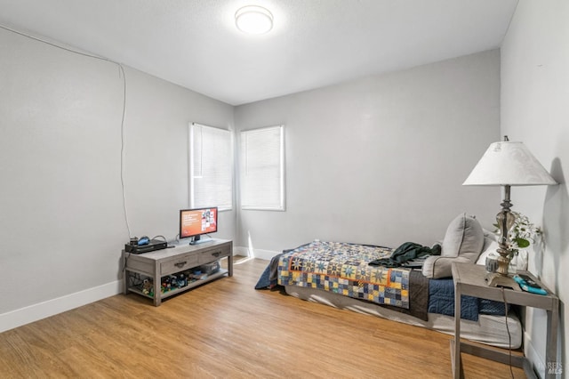 bedroom with wood-type flooring